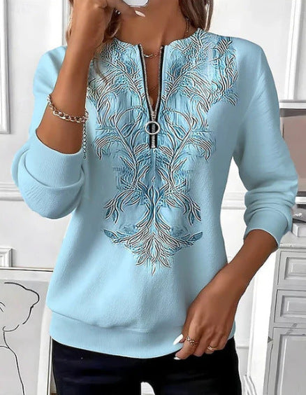 Elina – Sweatshirt med lynlås og gyldent ornamentmønster